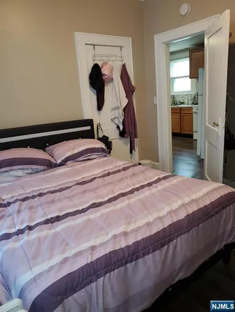 a bedroom with a bed and a mirror