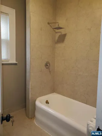 a bathroom with a tub and a shower