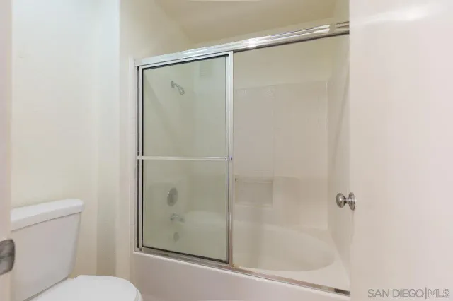 a bathroom with a shower and a toilet