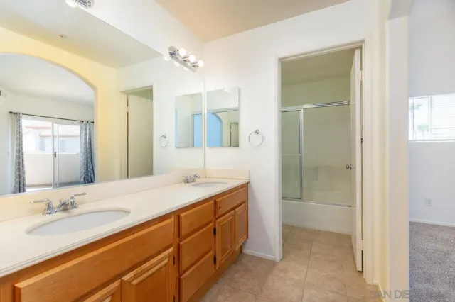 a bathroom with a granite countertop sink mirror and double
