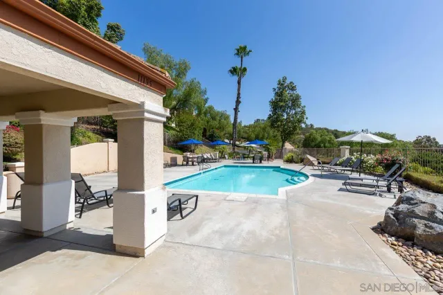 a view of a house with wooden fence