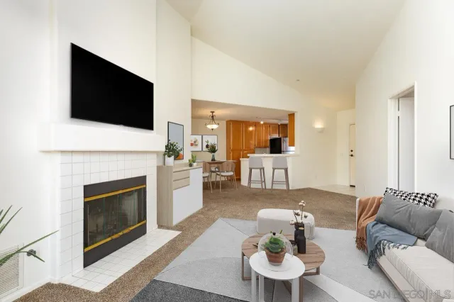 a living room with furniture a fireplace and a flat screen tv