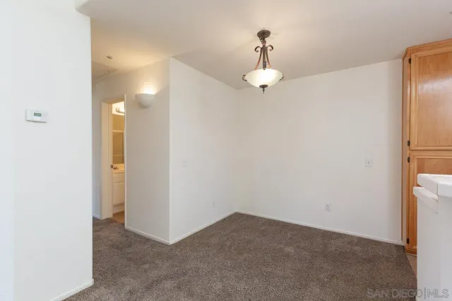 a view of an empty room and a bathroom