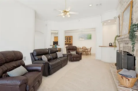 a living room with furniture fireplace and a chandelier