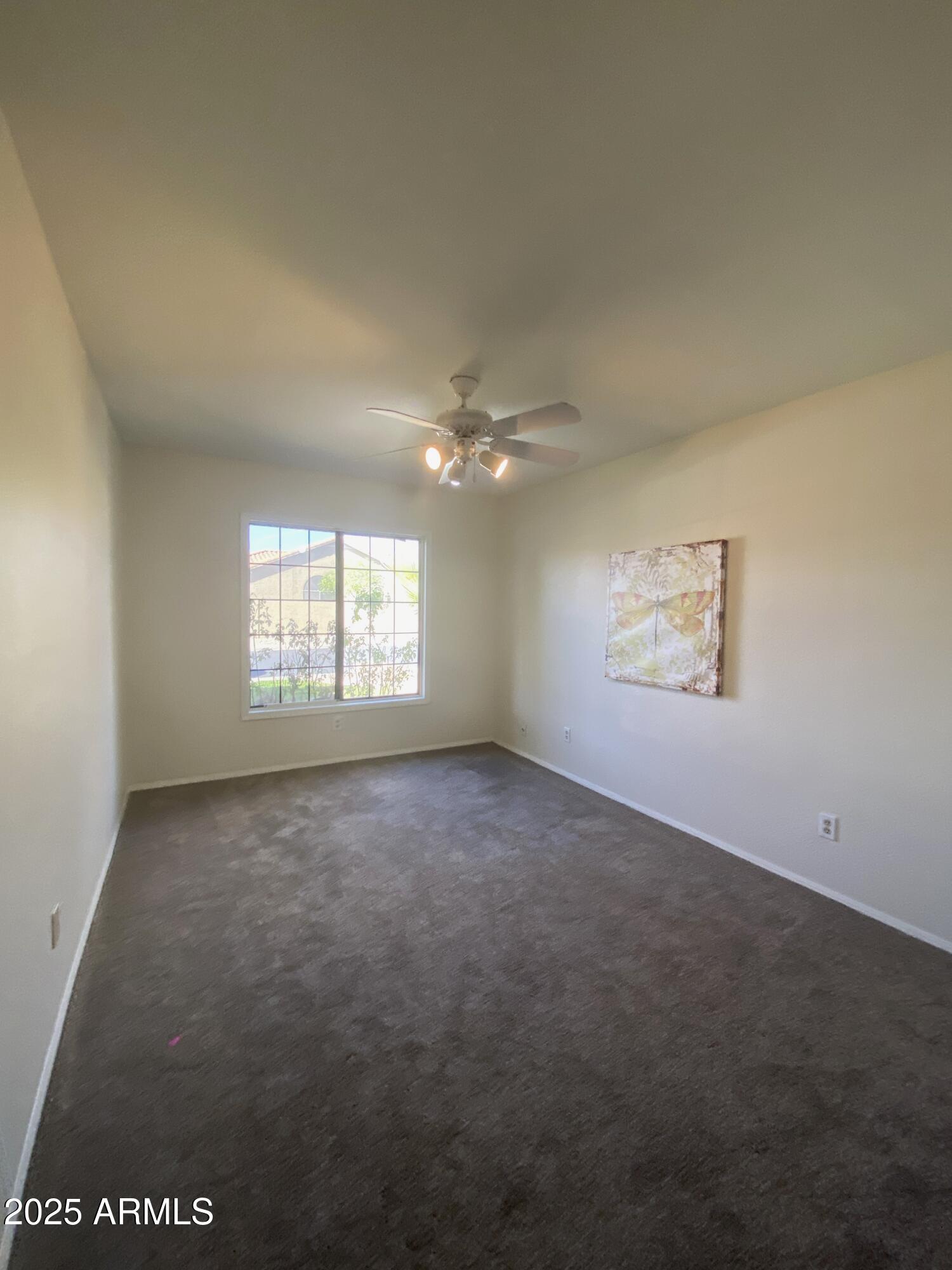 15017 South 25th Way Phoenix, AZ 85048 - Photo 11 of 18 an empty room with windows and fan