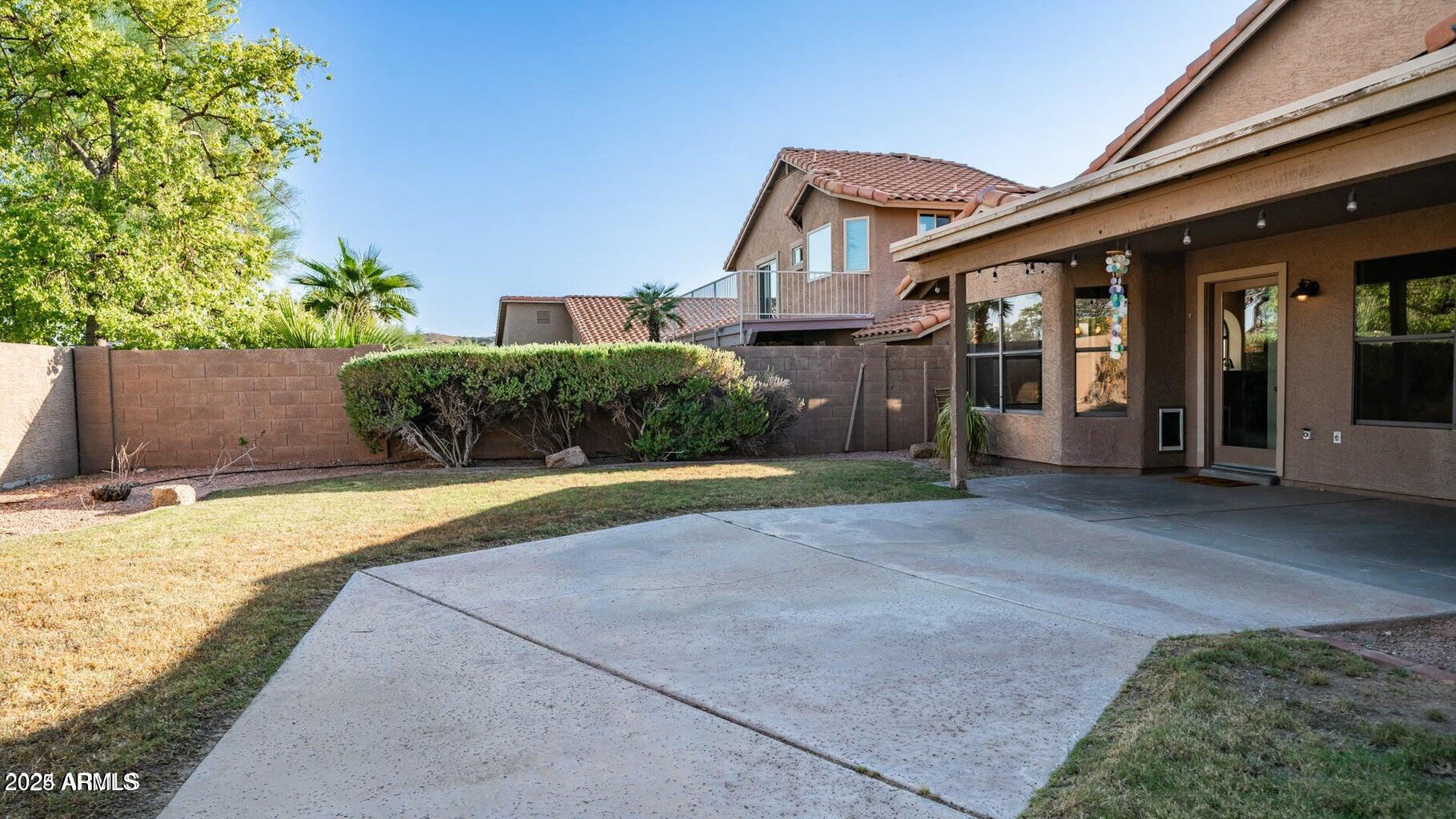 15017 South 25th Way Phoenix, AZ 85048 - Photo 16 of 18 a front view of a house with a yard and garage