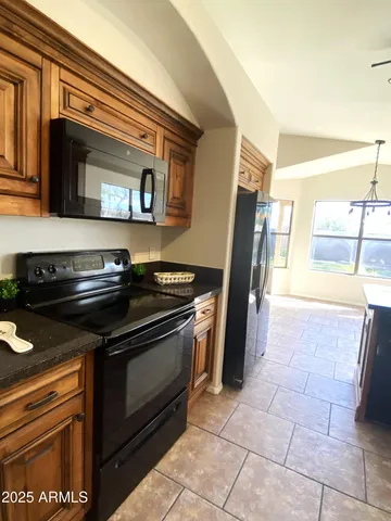 a stove top oven sitting inside of a kitchen