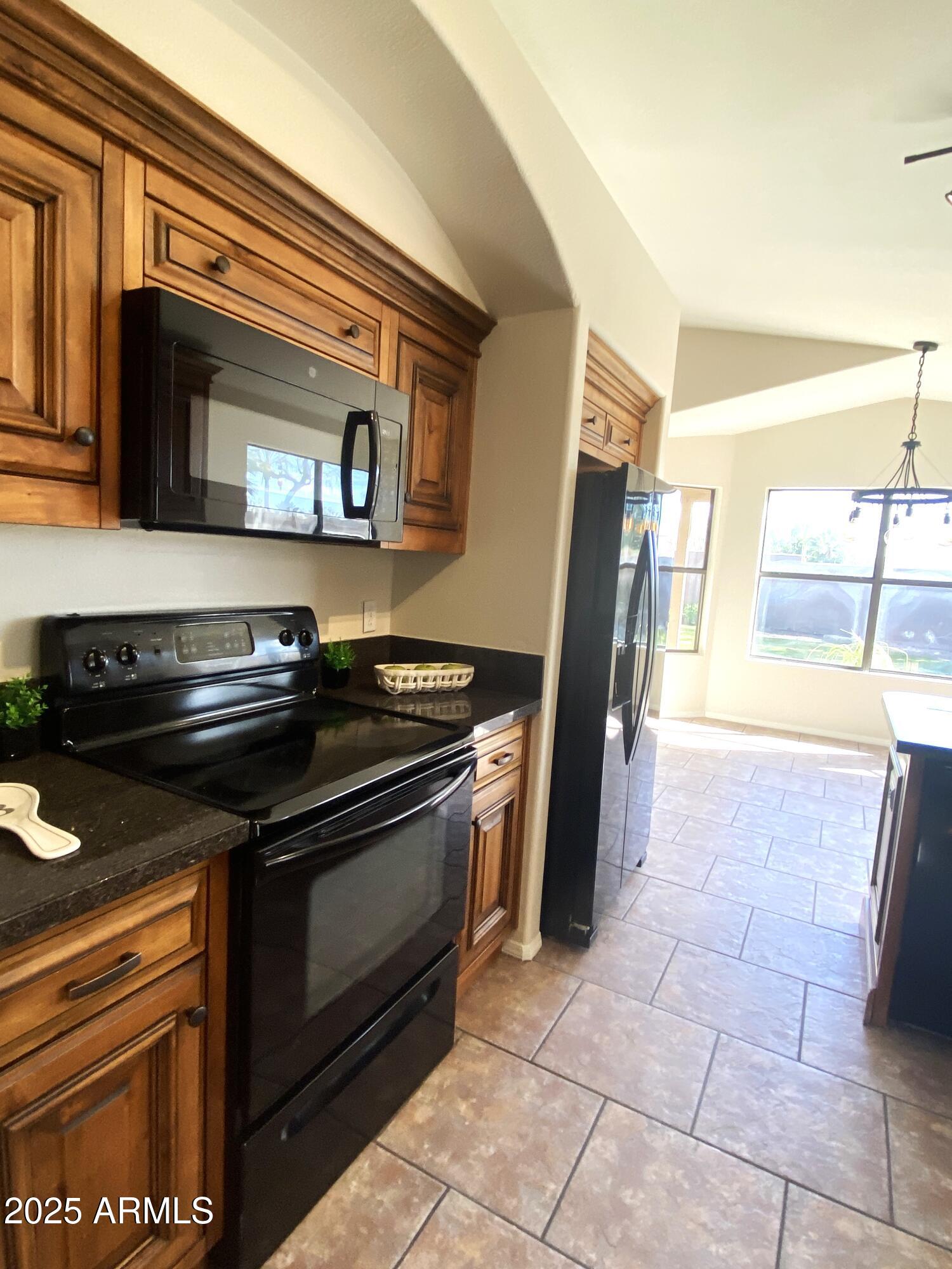 15017 South 25th Way Phoenix, AZ 85048 - Photo 6 of 18 a stove top oven sitting inside of a kitchen