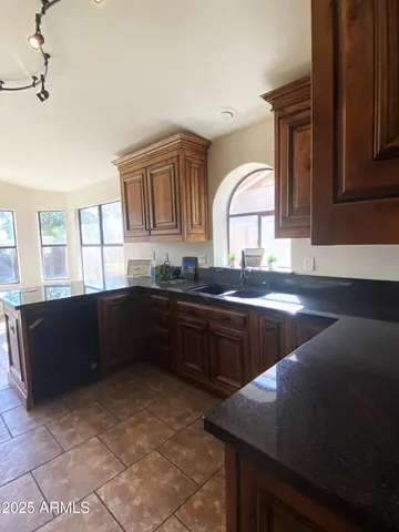 a kitchen with a sink a counter top space and cabinets