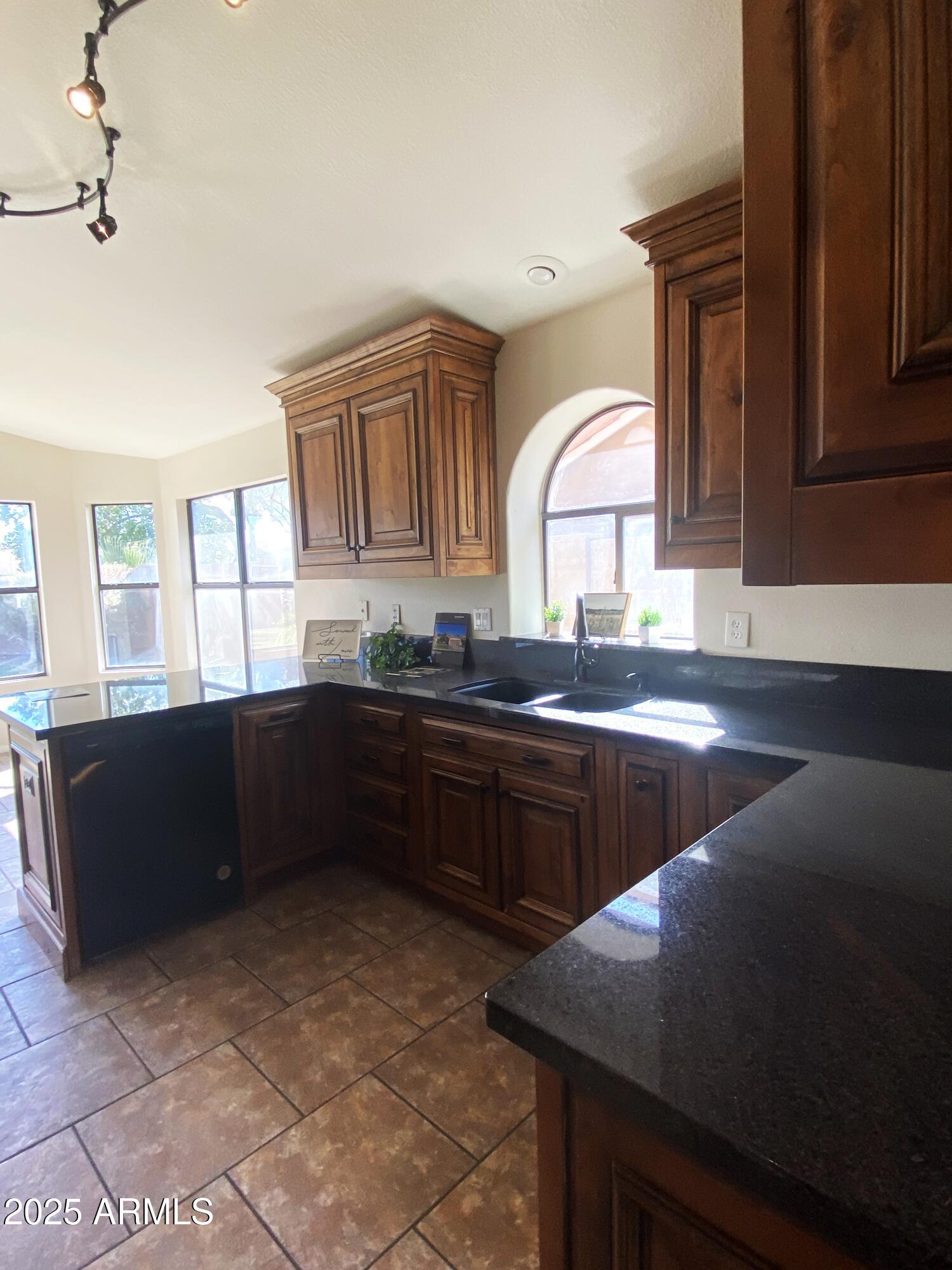 15017 South 25th Way Phoenix, AZ 85048 - Photo 7 of 18 a kitchen with a sink a counter top space and cabinets