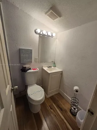a bathroom with a toilet a sink and a mirror