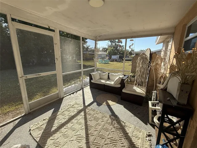 a balcony with furniture and a potted plant