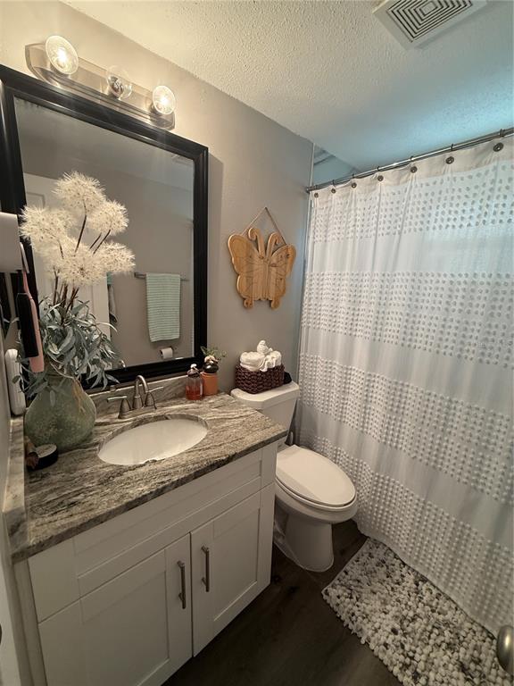 600 Briarwood Road Venice, FL 34293 - Photo 8 of 13 a bathroom with a granite countertop sink a toilet and a mirror
