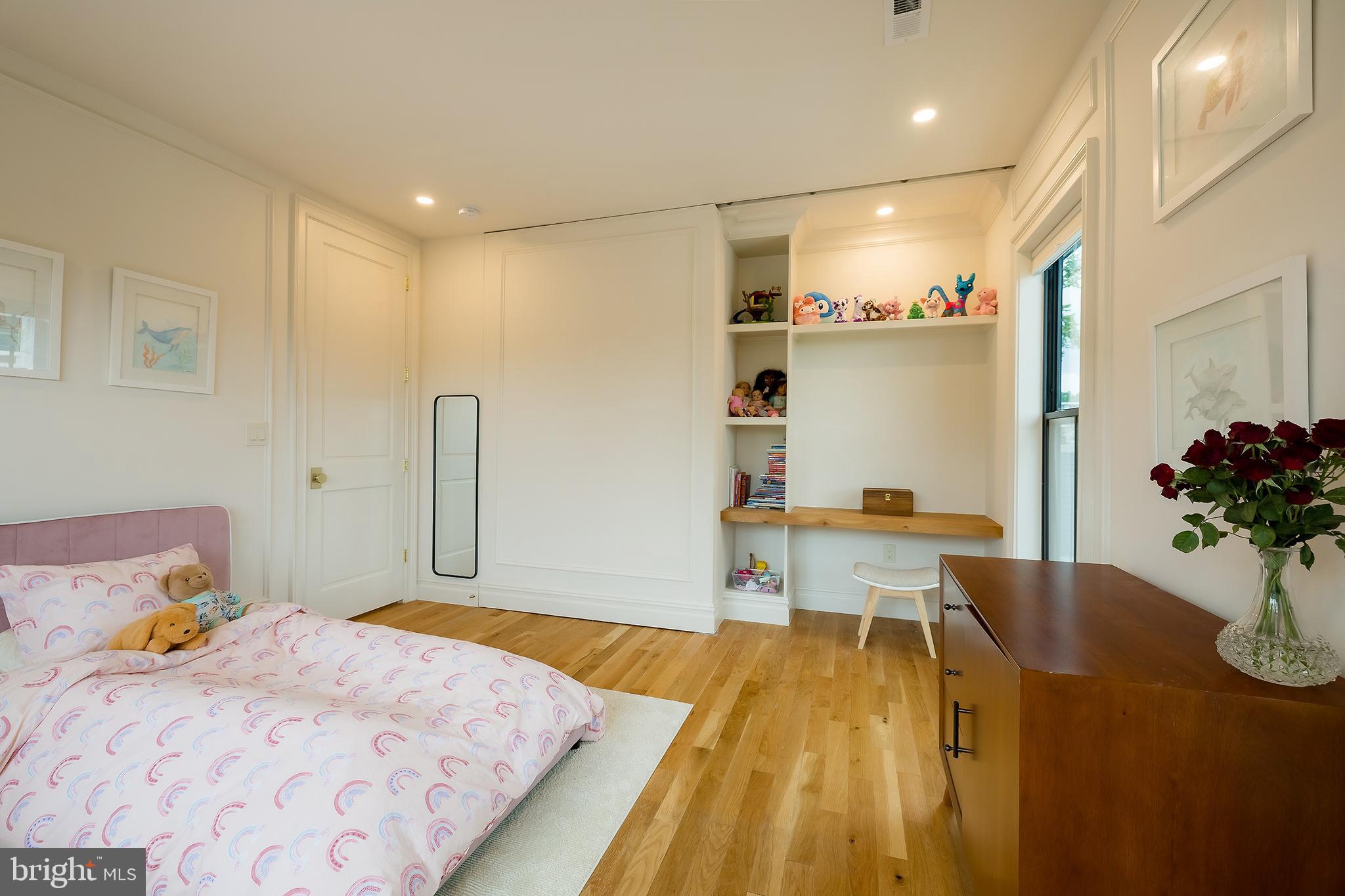 1207 Randolph Street Northeast Washington, DC 20017 - Photo 30 of 47 a bedroom with a bed and a table in it