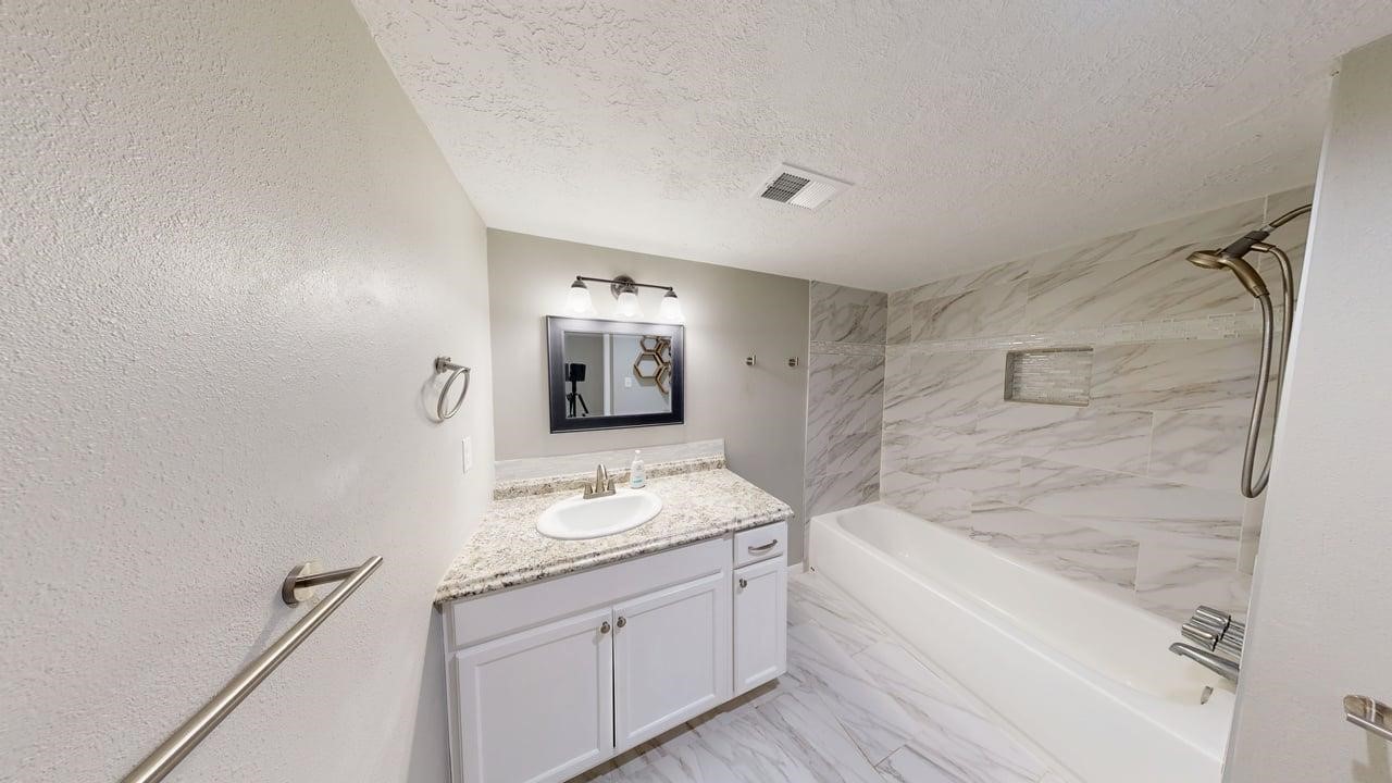 619 Cotter Drive Spring, TX 77373 - Photo 13 of 50 a bathroom with a granite countertop sink a mirror and a bathtub