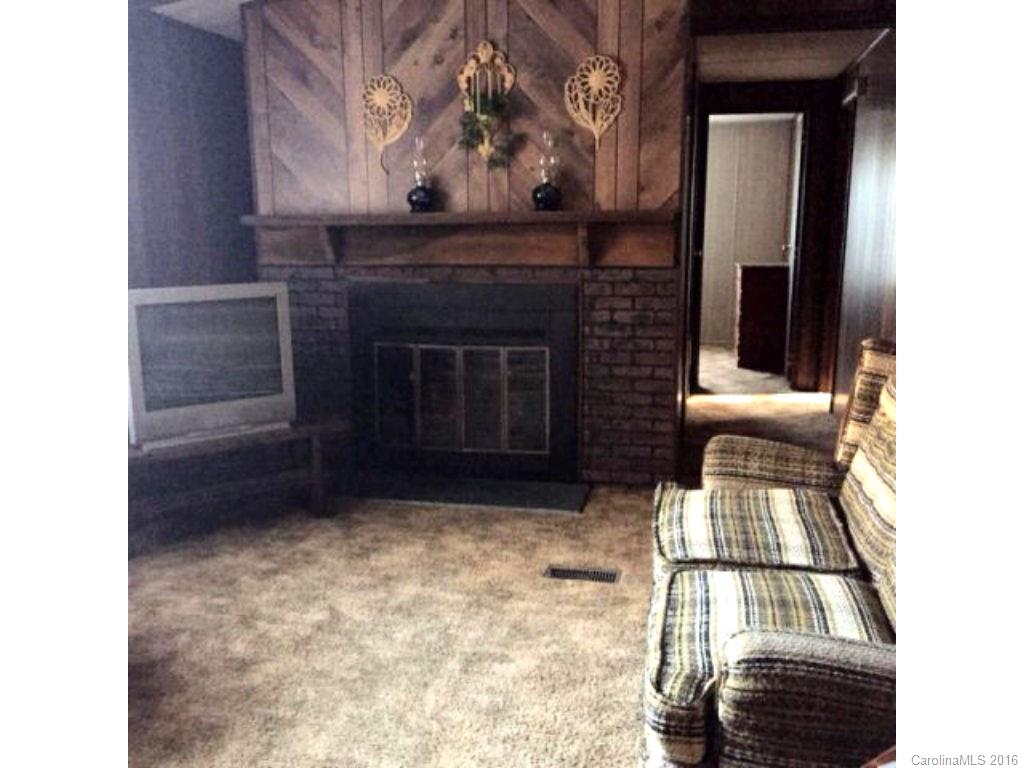8508 Alarka Road Bryson City, NC 28713 - Photo 3 of 13 a view of an empty room with a fireplace