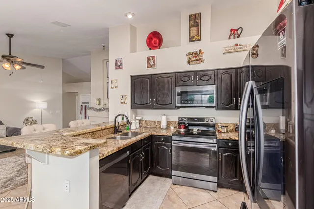a kitchen with stainless steel appliances granite countertop a stove and a refrigerator