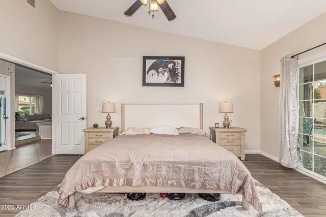 a bedroom with a large bed and a chandelier