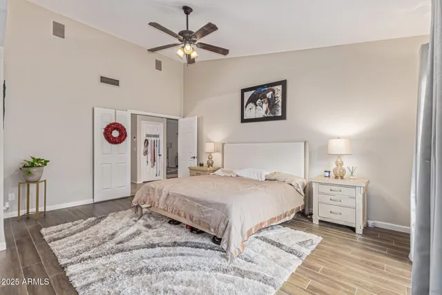 a bedroom with a large bed and a chandelier