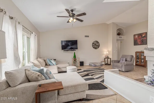 a living room with furniture a large window and a flat screen tv