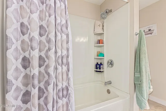 a bathroom with a bathtub and a shower curtain