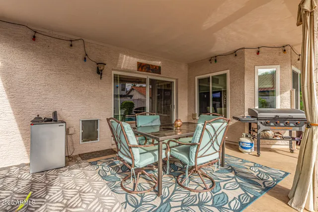a view of a patio with table and chairs