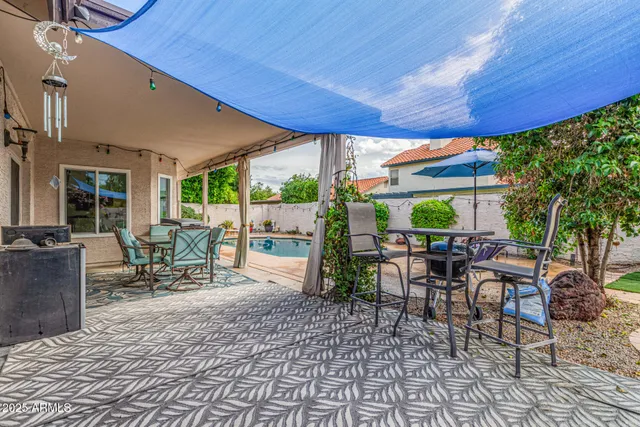 a patio with table and chairs