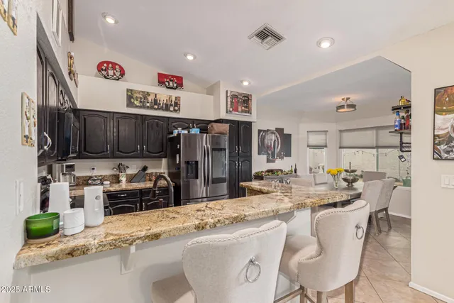 a kitchen with stainless steel appliances kitchen island granite countertop a sink and cabinets