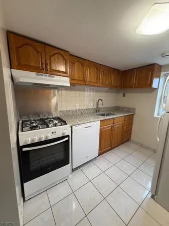 a kitchen with a stove sink and cabinets