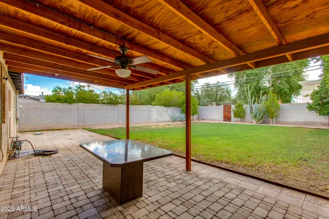 a view of a house with a backyard