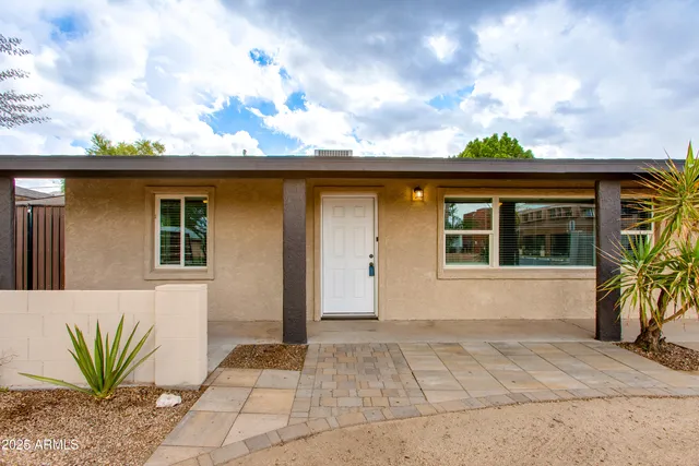 a front view of a house with a garden