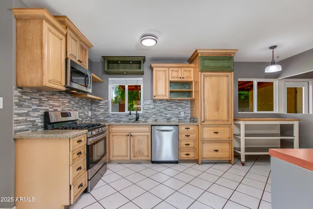 a kitchen with stainless steel appliances granite countertop a stove and a sink