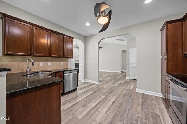a kitchen with stainless steel appliances and wooden cabinets