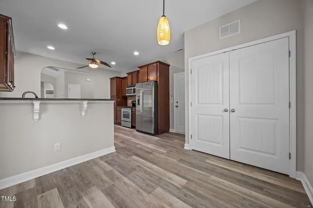 a view of a kitchen with a dishwasher cabinets and wooden floor