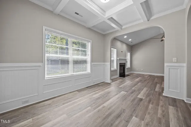 wooden floor in an empty room with a window