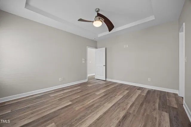 a bathroom with a granite countertop sink a toilet and a mirror