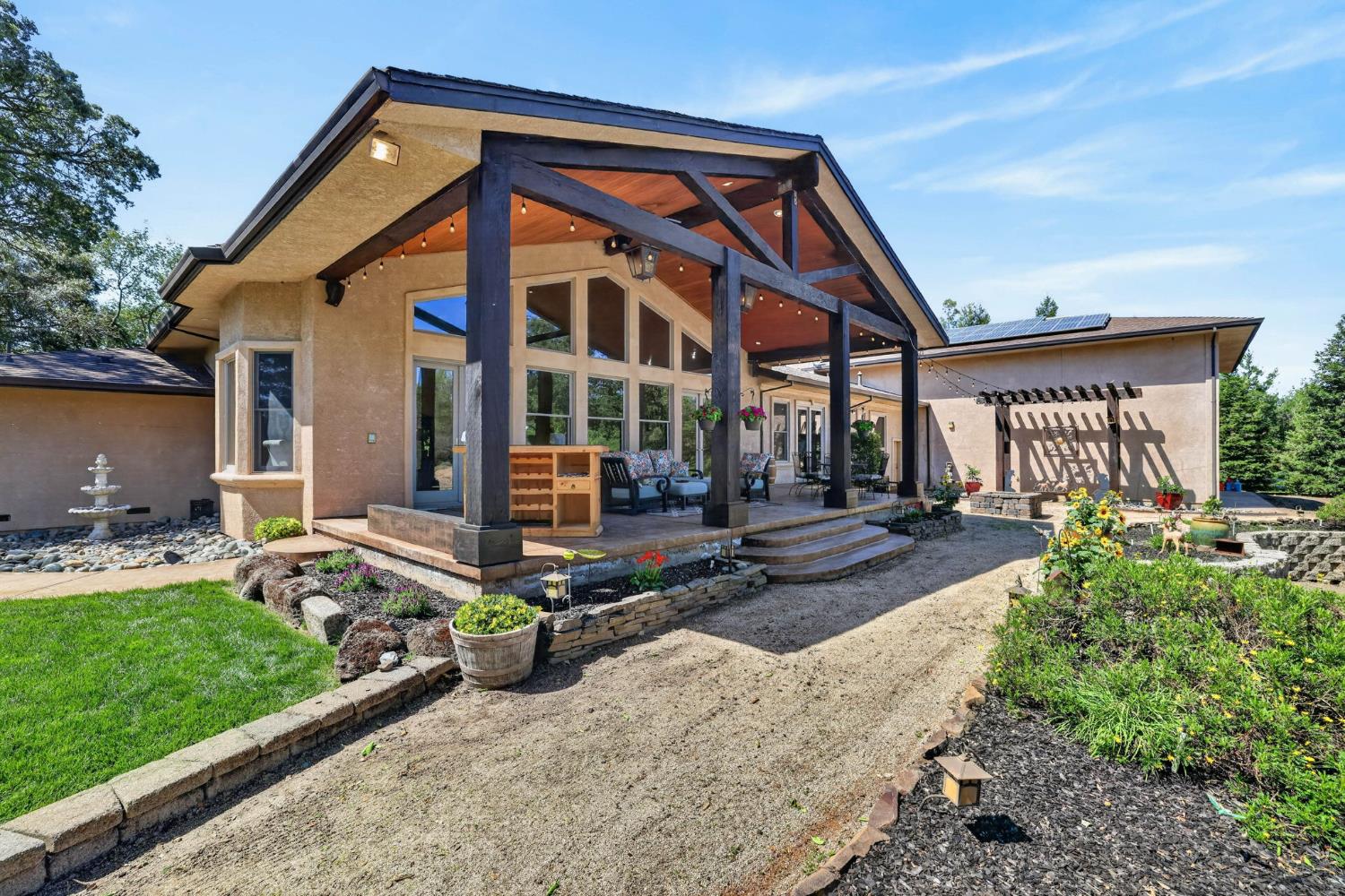 7021 Horseshoe Bar Road Loomis, CA 95650 - Photo 47 of 77 a front view of a house with garden and patio