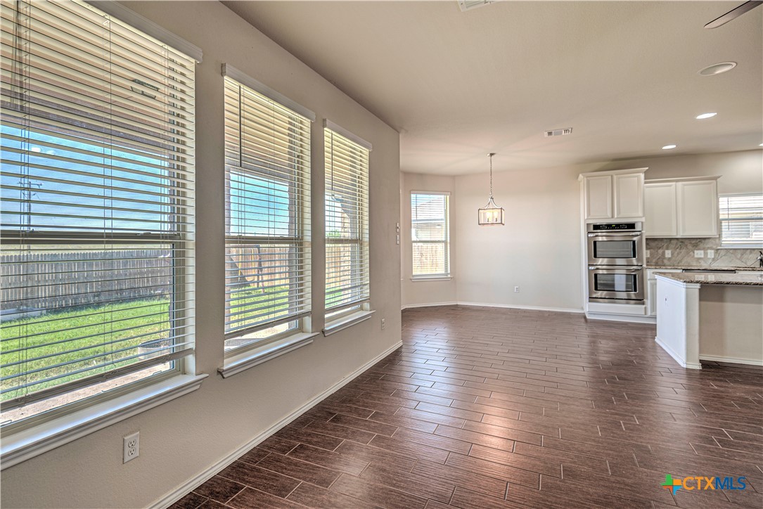 9207 Lake Pointe Drive Temple, TX 76502 - Photo 9 of 42 a view of empty room with wooden floor and windows