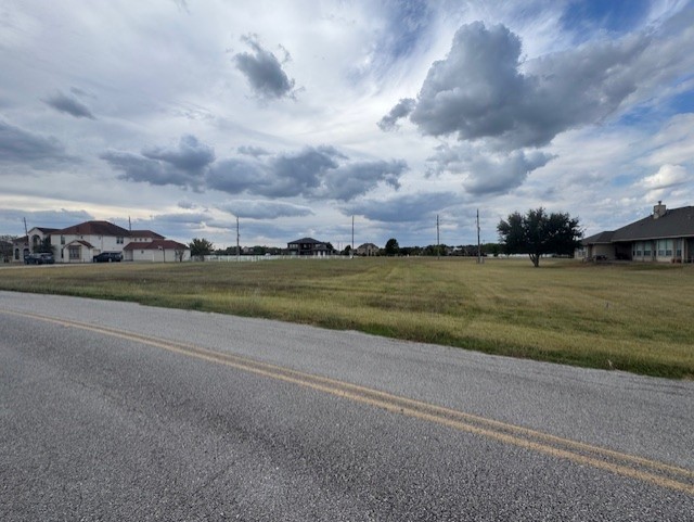 a view of a lake with houses in the back
