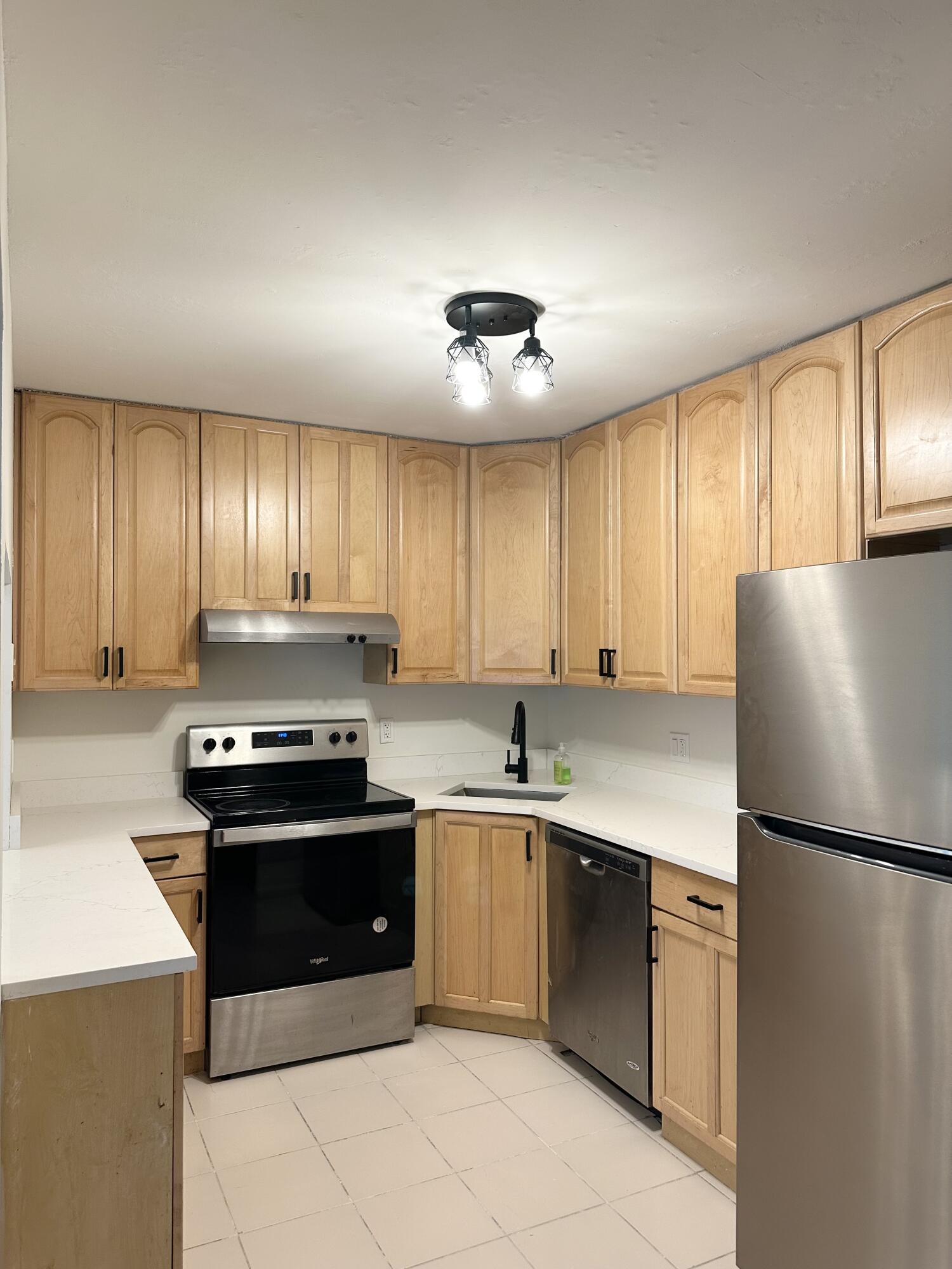 4779 Sable Pine Circle, Unit B2 West Palm Beach, FL 33417 - Photo 1 of 21 a kitchen with cabinets stainless steel appliances and window