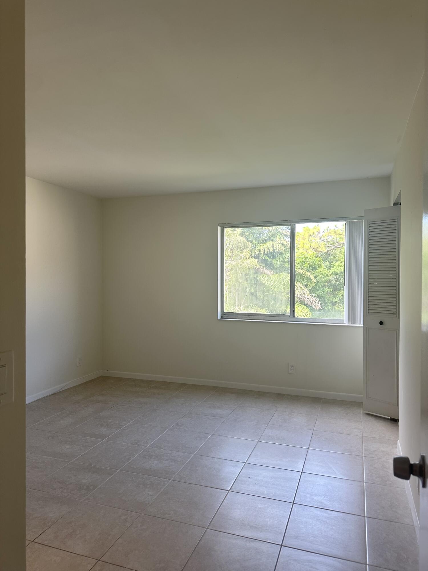 4779 Sable Pine Circle, Unit B2 West Palm Beach, FL 33417 - Photo 13 of 21 an empty room with a window