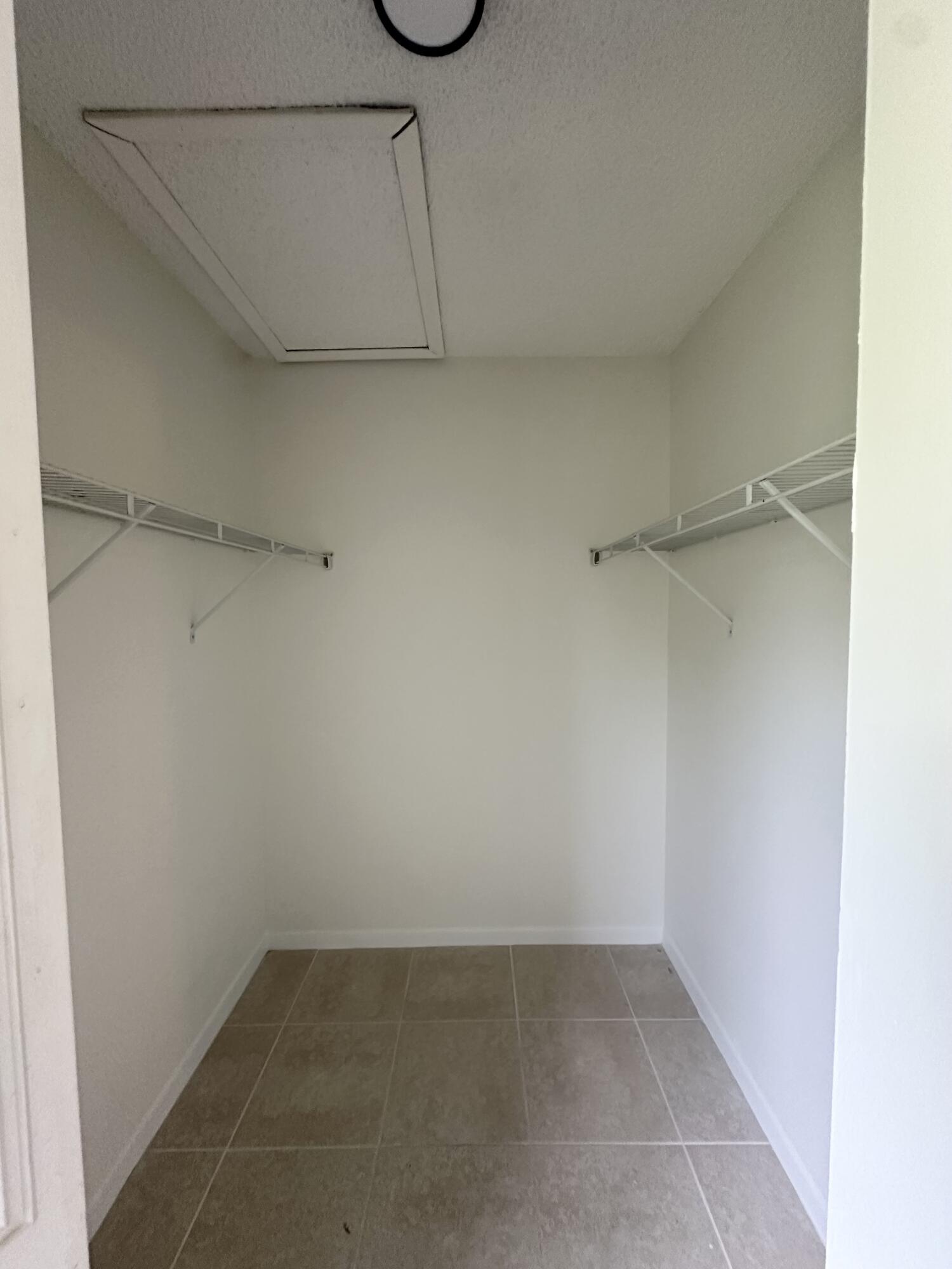 4779 Sable Pine Circle, Unit B2 West Palm Beach, FL 33417 - Photo 19 of 21 a view of a room with racks on the wall