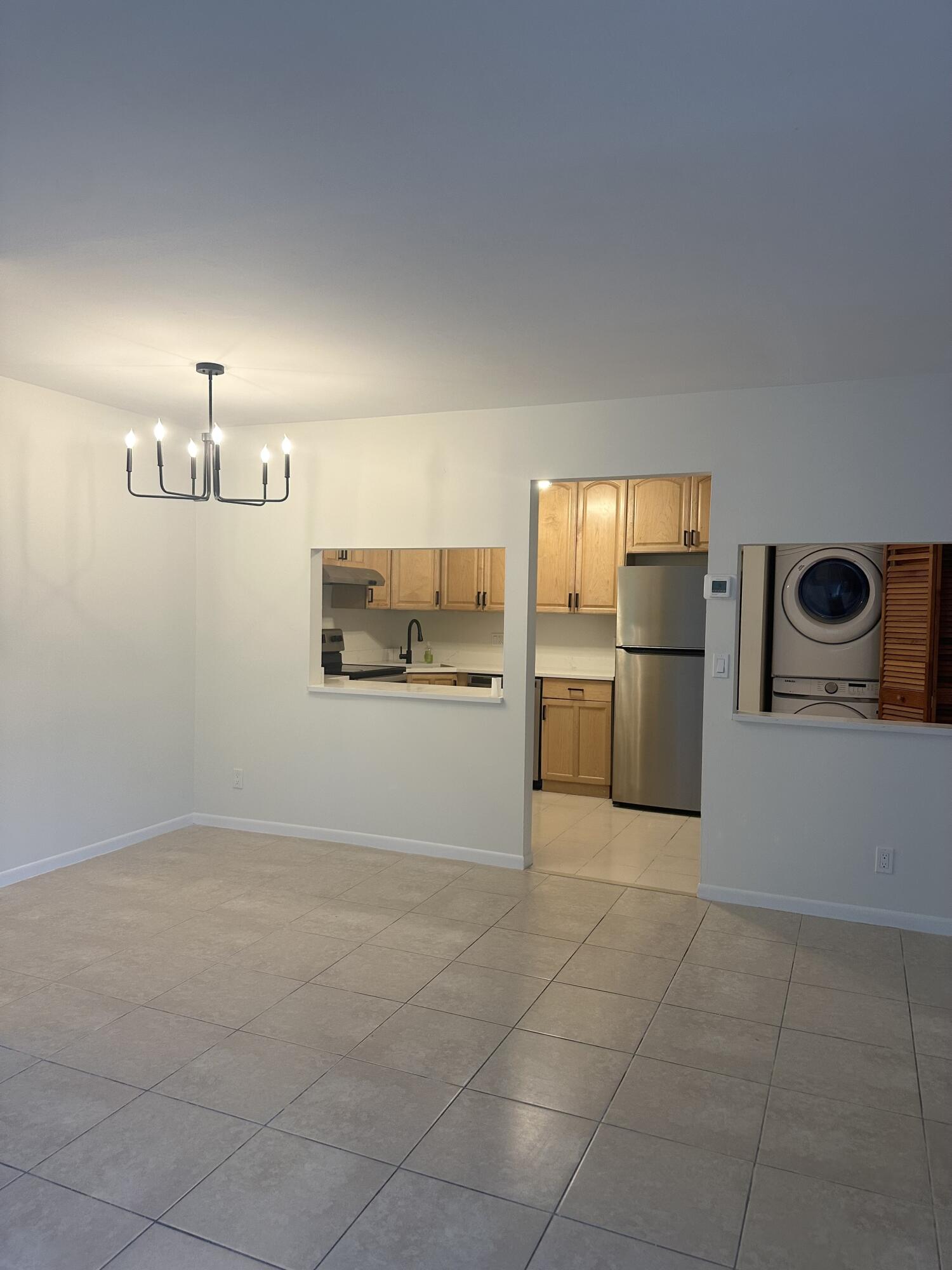 4779 Sable Pine Circle, Unit B2 West Palm Beach, FL 33417 - Photo 5 of 21 a kitchen with cabinets and refrigerator