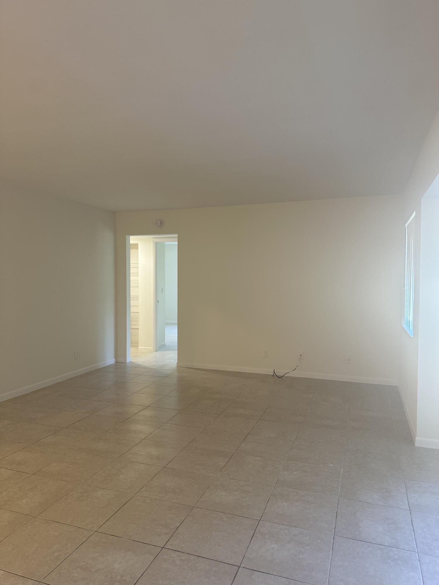 4779 Sable Pine Circle, Unit B2 West Palm Beach, FL 33417 - Photo 10 of 21 an empty room with windows