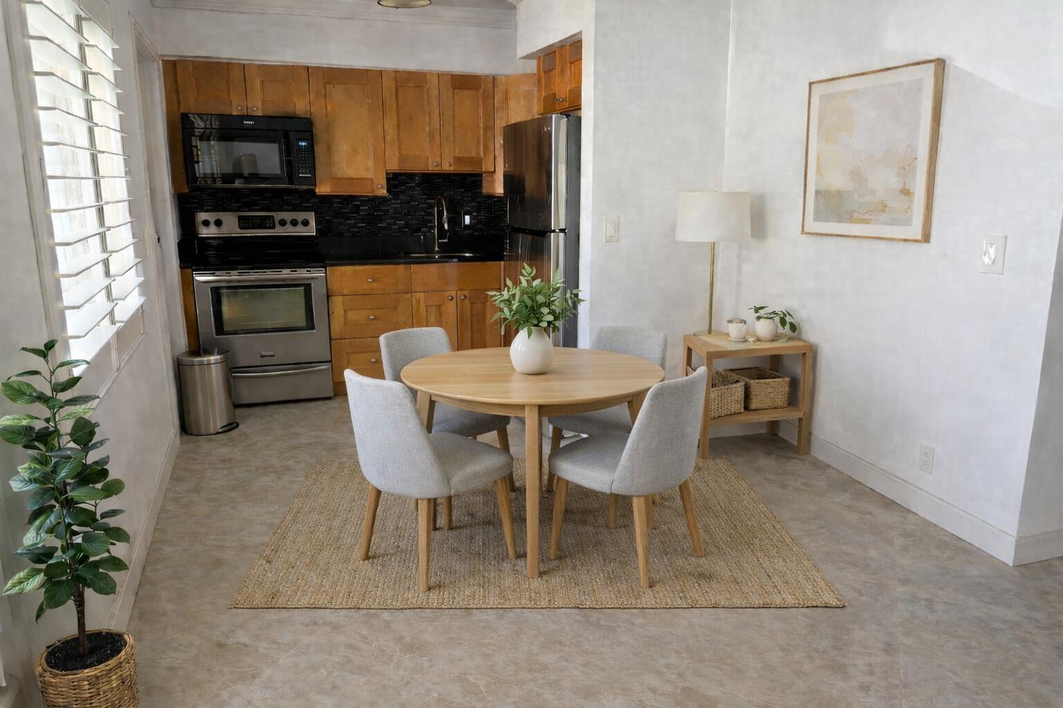 2131 Northeast 42nd Court, Unit 202E Lighthouse Point, FL 33064 - Photo 1 of 23 a dining room with furniture and kitchen view