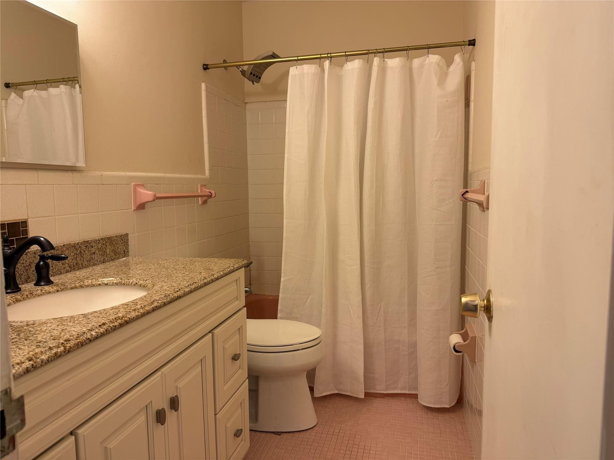 2131 Northeast 42nd Court, Unit 202E Lighthouse Point, FL 33064 - Photo 15 of 23 a bathroom with a granite countertop sink toilet and shower