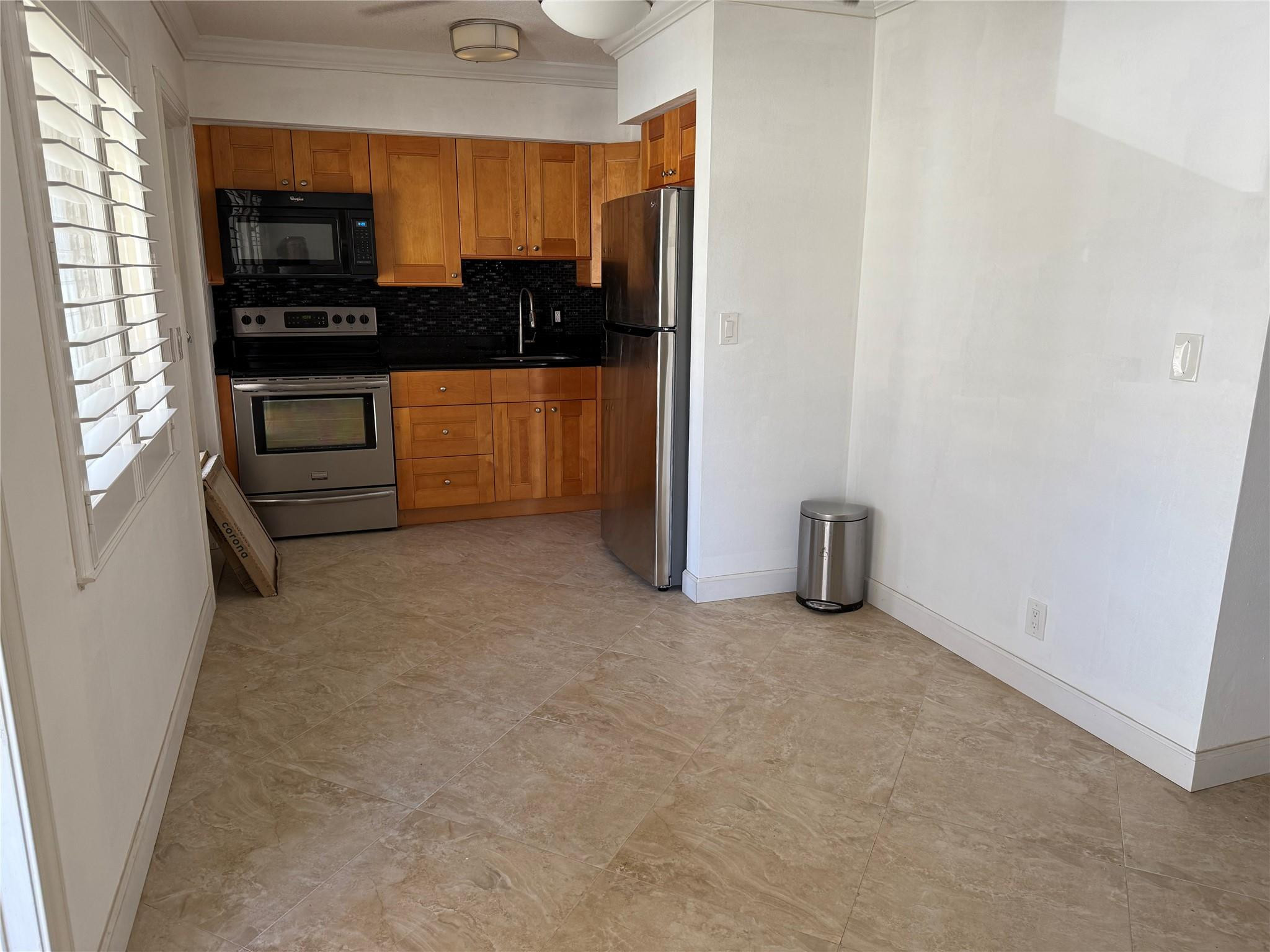 2131 Northeast 42nd Court, Unit 202E Lighthouse Point, FL 33064 - Photo 3 of 23 an empty room with a fireplace