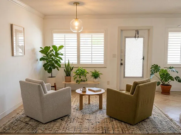 a living room with furniture and a potted plant