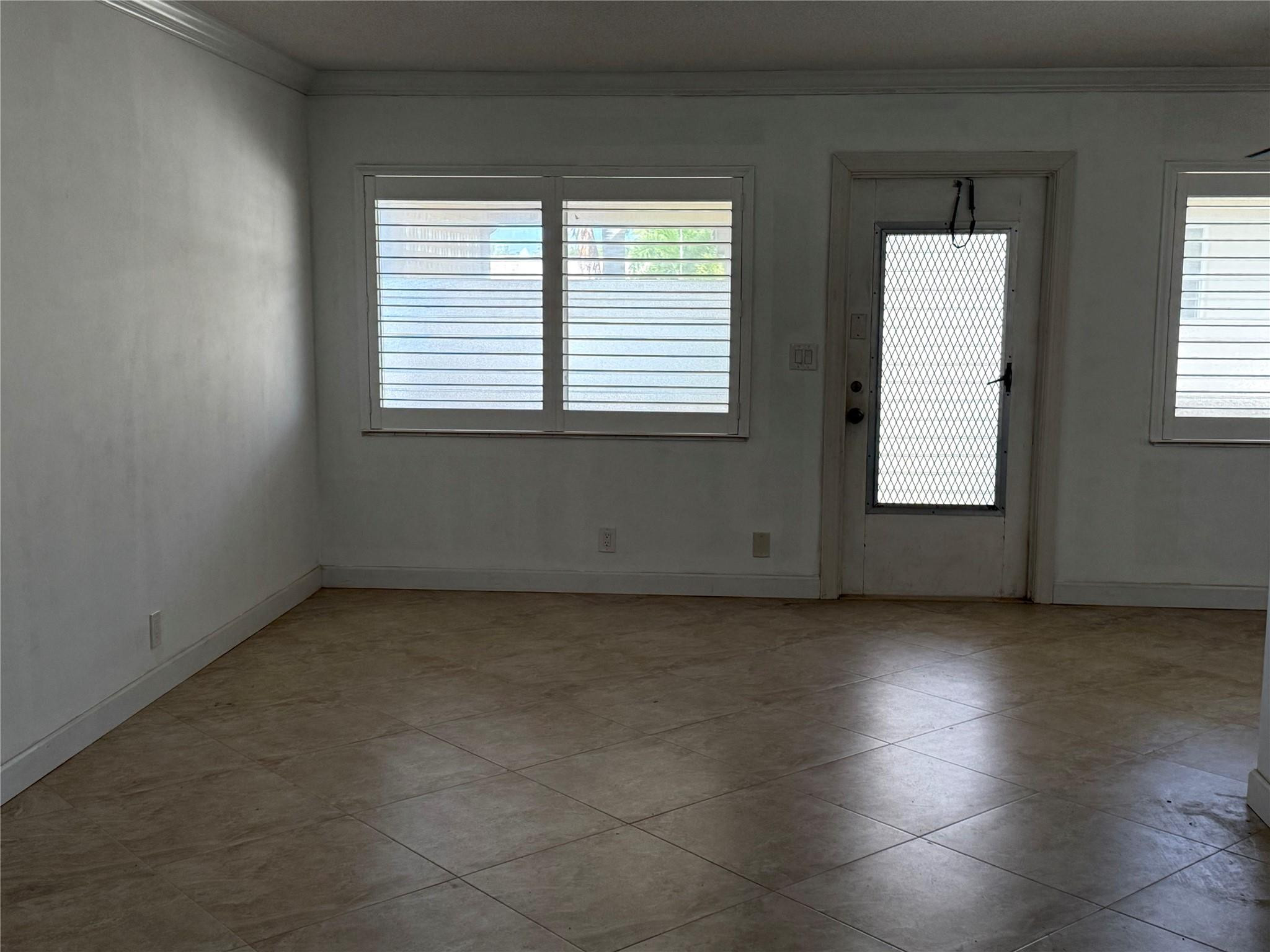 2131 Northeast 42nd Court, Unit 202E Lighthouse Point, FL 33064 - Photo 5 of 23 an empty room with wooden floor and windows