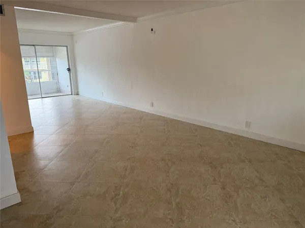 a bedroom with a bed a flat screen tv and dresser
